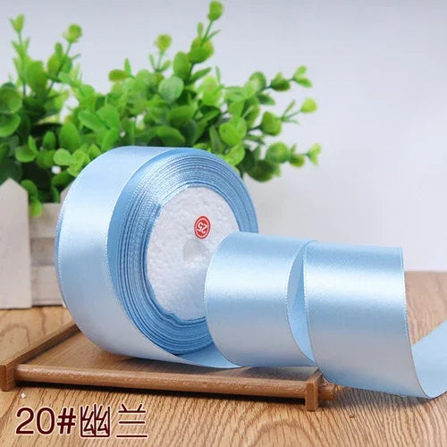 Roll of light blue satin ribbon for gift wrapping and DIY crafts