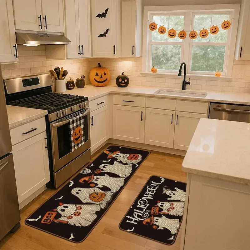 A set of Halloween ghost pumpkin print non-slip kitchen rugs placed on a wooden floor.