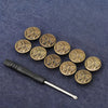 A set of ten antique brass snap buttons arranged in a line on a dark blue fabric background.