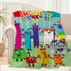 A colorful cartoon number blocks blanket featuring various animal characters and numbers.