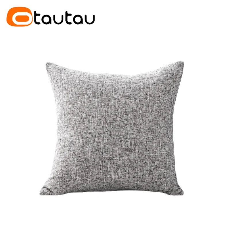 A square gray linen cushion cover with a button closure.