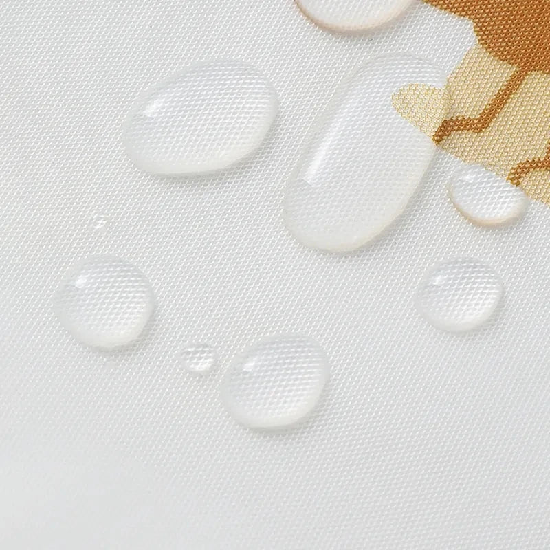 Several clear, round droplets of liquid are scattered on a white fabric surface.