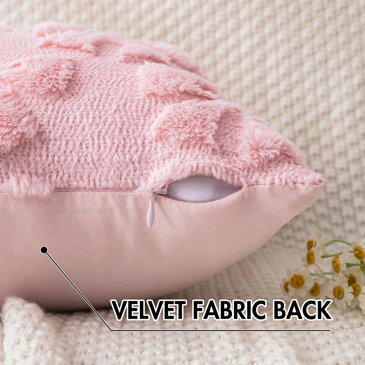 Close-up of a pink faux fur pillow cover showing the velvet fabric back and a stitched detail.
