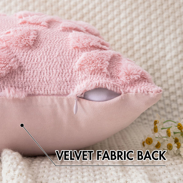 Close-up of a pink faux fur pillow cover showing the velvet fabric back and a stitched detail.