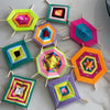 A collection of colorful, geometric crochet kits made from milk cotton yarn arranged on a white surface.