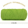 A tightly wound ball of bright lime green thick polyester blended yarn for crafting.
