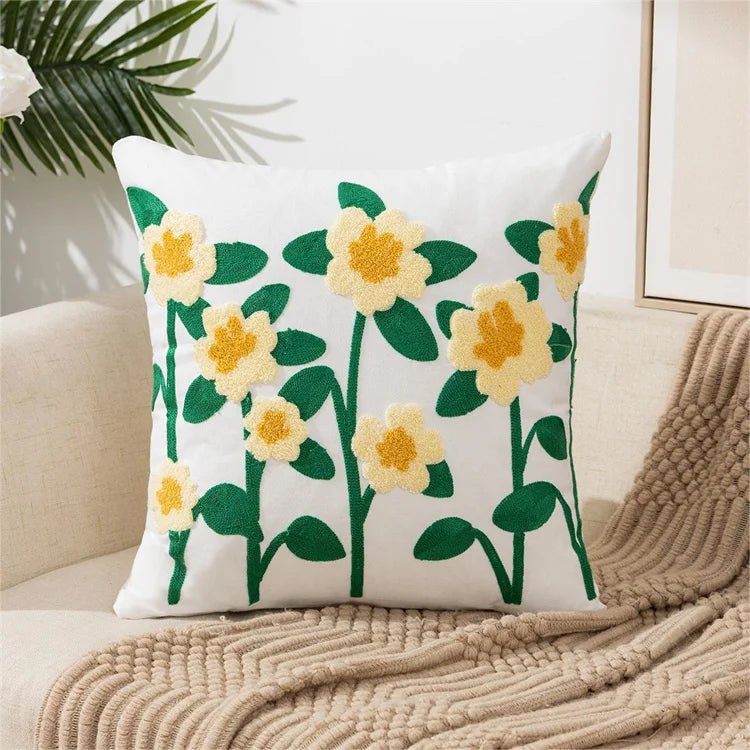 White throw pillow cover embroidered with yellow and green floral designs