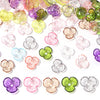Assortment of colorful resin flower bead caps for jewelry making in various shades of pink, purple, green, and clear.