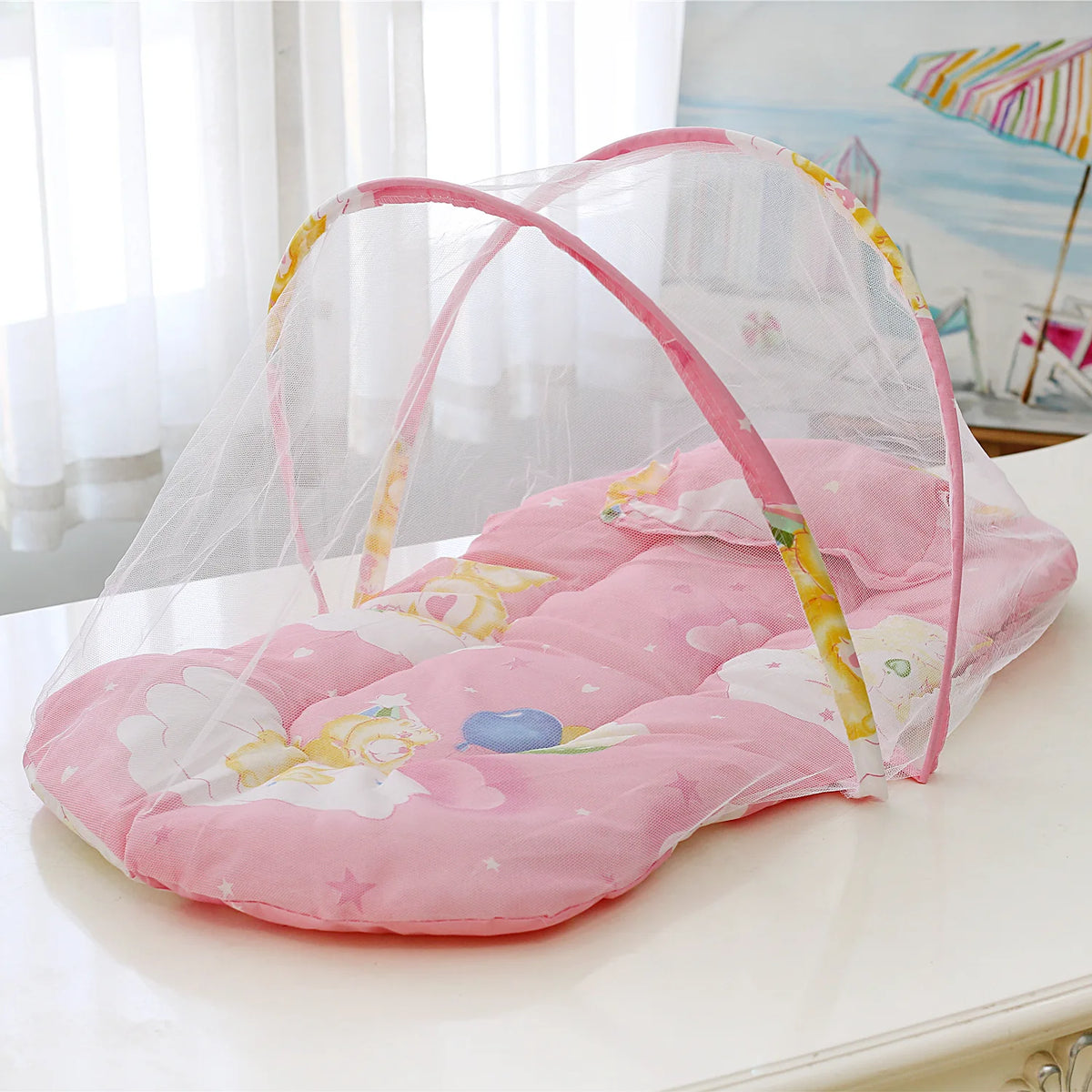 Pink foldable baby mosquito net sleeping tent with a clear mesh cover and floral patterns