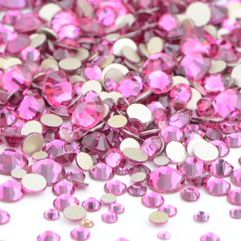 A pile of pink and clear glass rhinestones for DIY crafts