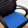 Honeycomb silicone seat cushion in blue resting on a black chair.