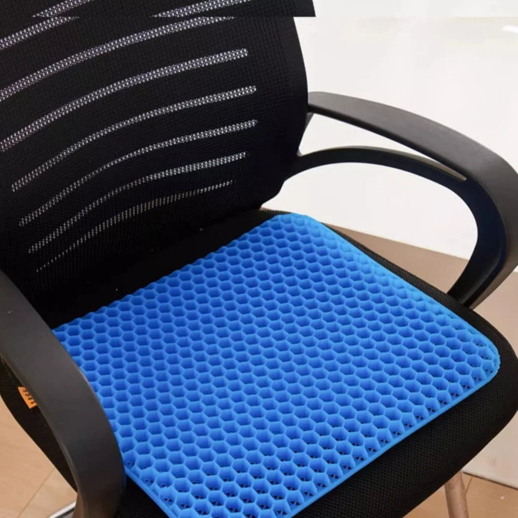 Honeycomb silicone seat cushion in blue resting on a black chair.