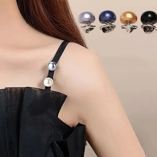 A close-up of a black garment featuring silver and gold pearl button pins for DIY decoration.