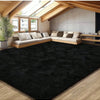 A large, dark black plush long-pile area rug placed in a modern living space with wooden beams and light-colored furniture.