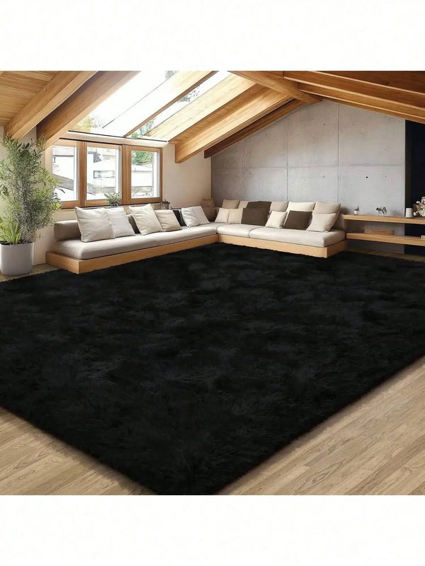 A large, dark black plush long-pile area rug placed in a modern living space with wooden beams and light-colored furniture.