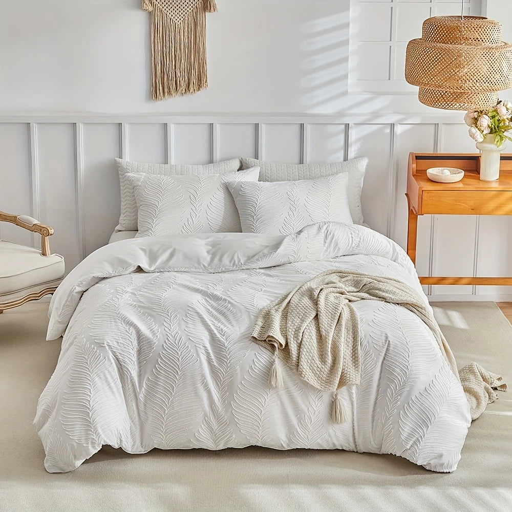 A white embossed leaf duvet cover set displayed on a bed with light wood accents and natural textiles.