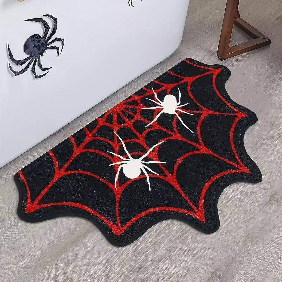Black decorative non-slip mat featuring a red spiderweb design for bathroom or kitchen use