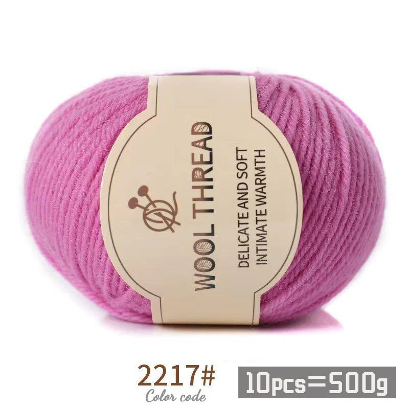 Pink wool thread skein with a label indicating delicate and soft intimate warmth