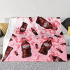 A pink cozy blanket featuring a repeating pattern of Dr. Pepper bottles with pink ribbons.