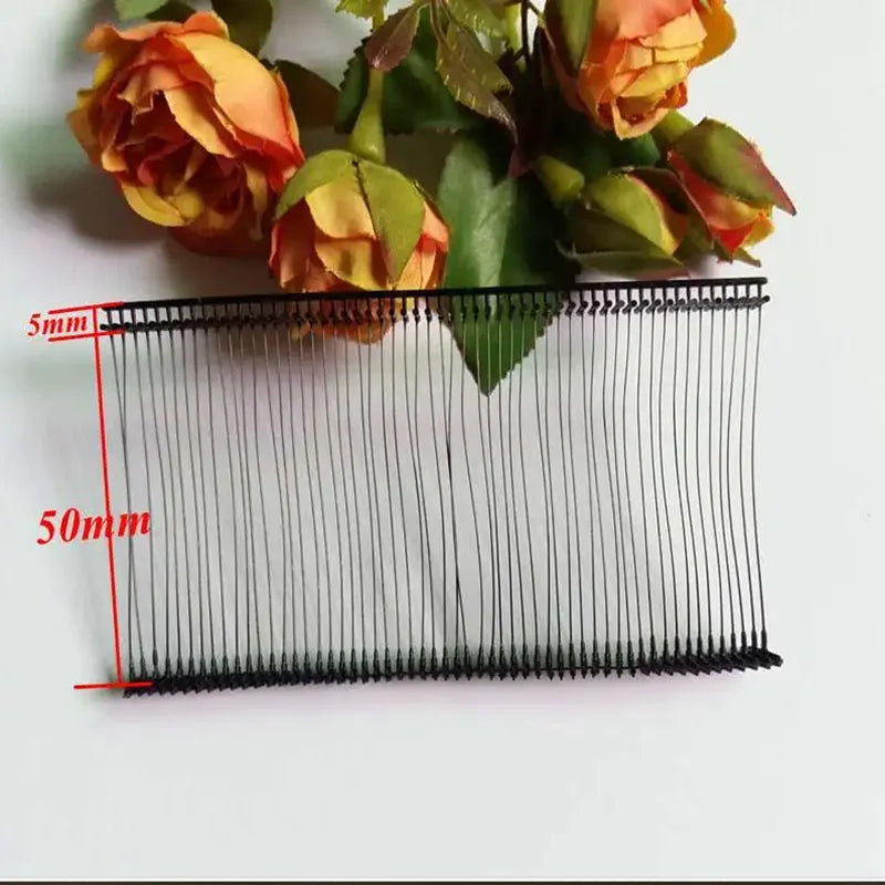 A close-up of a precision plastic tagging barbs used for labels, showing the fine serrated edges and measurement lines.