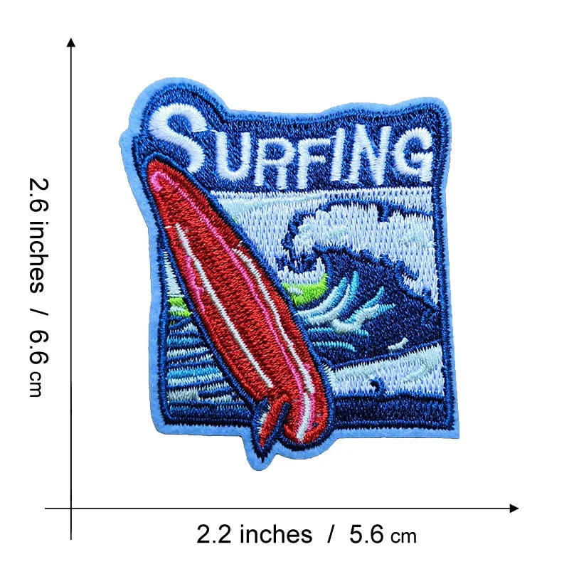 Blue embroidered patch featuring the word SURFING and a red fish swimming in a blue wave.