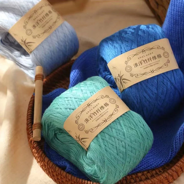 A collection of blue and teal yarn balls wrapped in natural fiber baskets for crafting