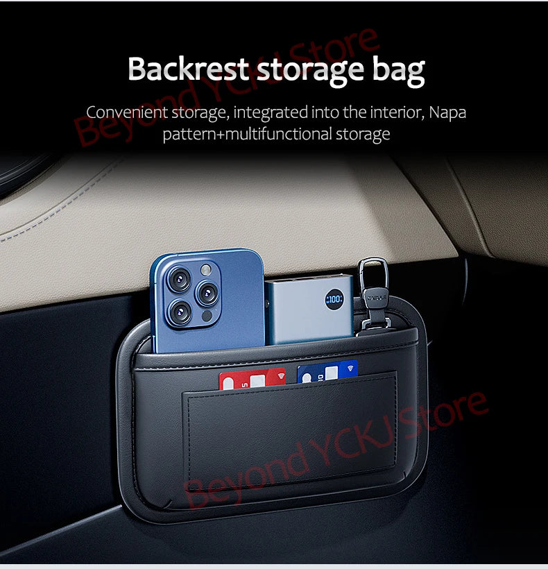 A dark gray storage bag with a zippered compartment holding a smartphone and a small electronic device, placed in a car inter
