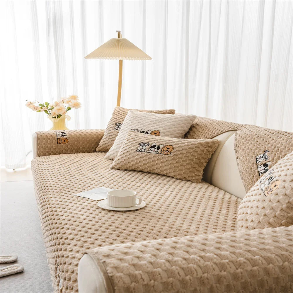 A beige plush sofa cover with decorative pillows and a light-colored floor lamp in a bright room.