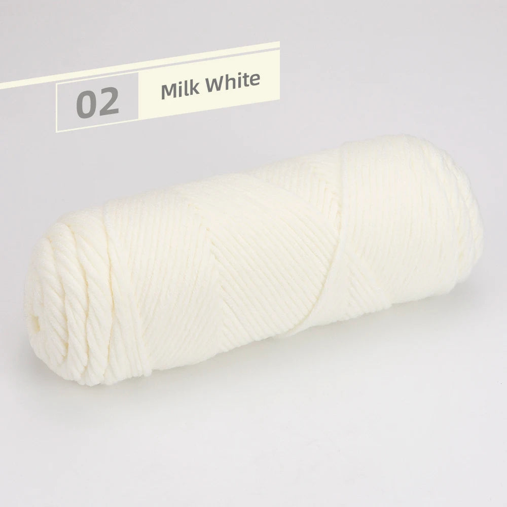 A spool of milk white yarn is shown rolled up against a white background.
