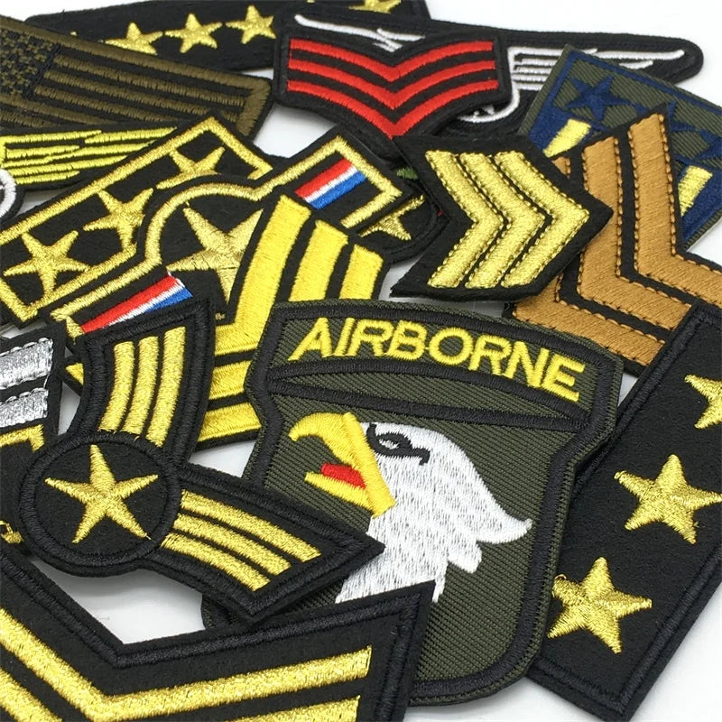 A set of embroidered tactical clothing patches featuring various military insignia and emblems.