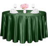 A dark green satin table overlay set for an event featuring pink flowers and glassware.