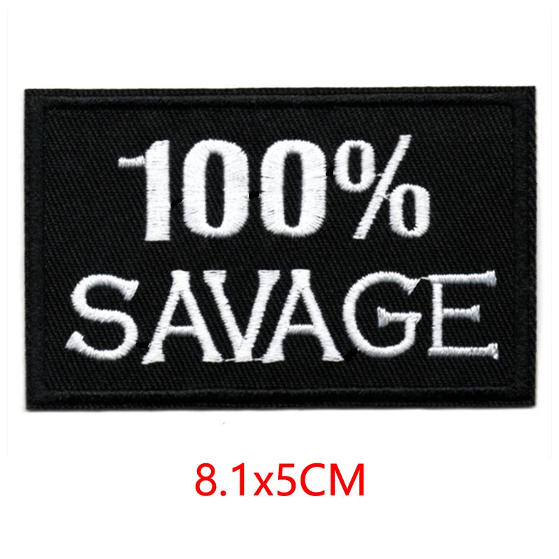 Black embroidered patch with white text saying 100% SAVAGE and dimensions 8.1x5cm