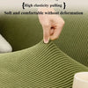 A hand gently pulls on a textured olive green sofa fabric demonstrating high elasticity and comfort without deformation.