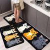 A set of black non-slip kitchen mats featuring various cat prints in white, orange, and gray on a light wood floor.