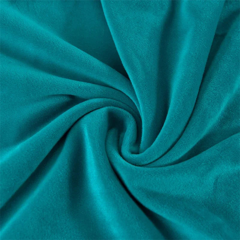 A close-up of a teal velvet fabric gathered into a swirl, showing the texture and drape.