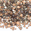 A close-up view of a mix of brown and gold clear glass rhinestones for DIY crafts.