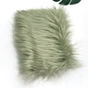 A square swatch of light sage green faux fur plush fabric for sewing and crafting.