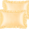 A set of two ruffled satin pillowcases in a pale yellow color with silky envelope closures.