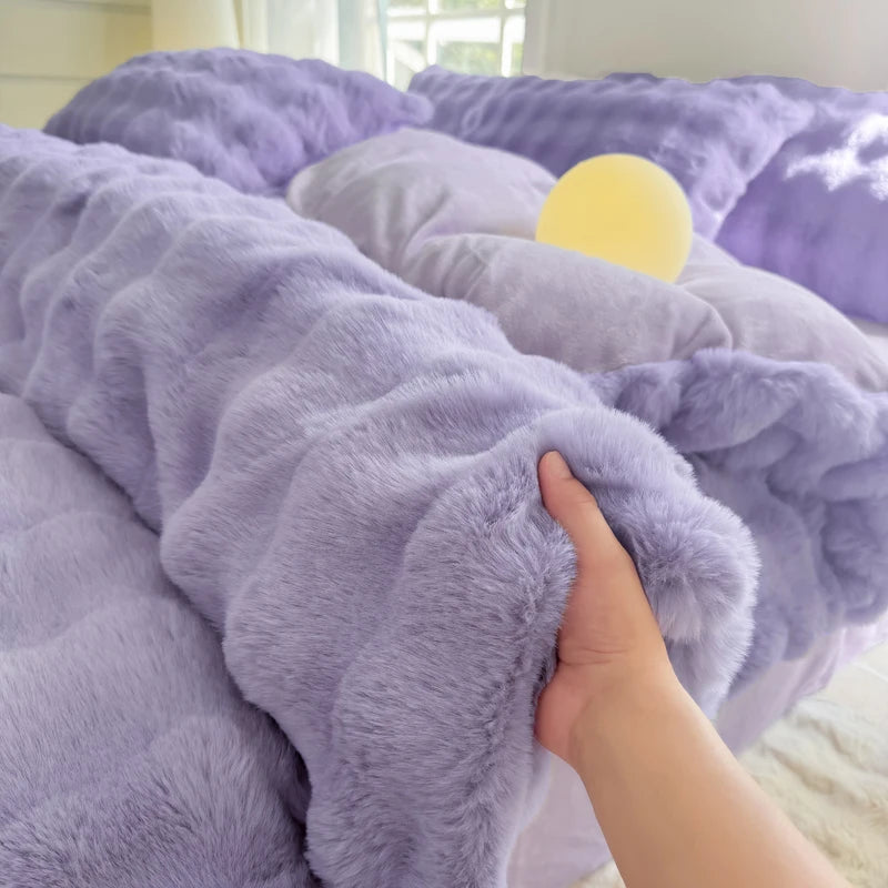 A close-up of a purple cozy rabbit fleece duvet cover with a yellow accent, being touched by a hand.