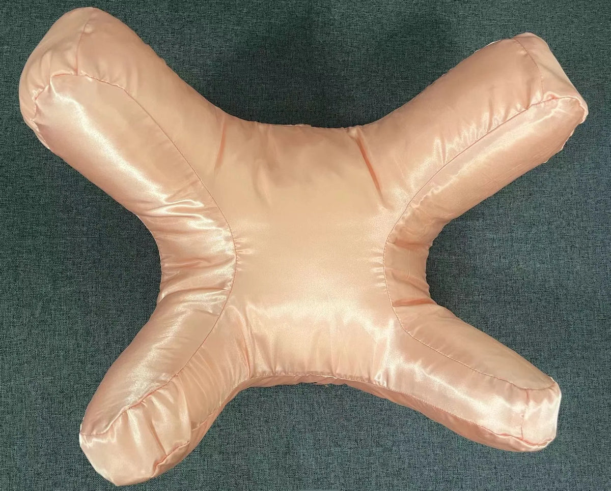 A light pink satin anti-wrinkle pillow shaped like a starfish.