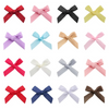 A collection of various satin ribbon bows in red, pink, yellow, black, and blue colors.