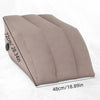 A beige inflatable leg elevation pillow shown from the side with measurements displayed.