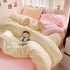 A bed with a solid cotton linen set featuring pale yellow and pink bedding.