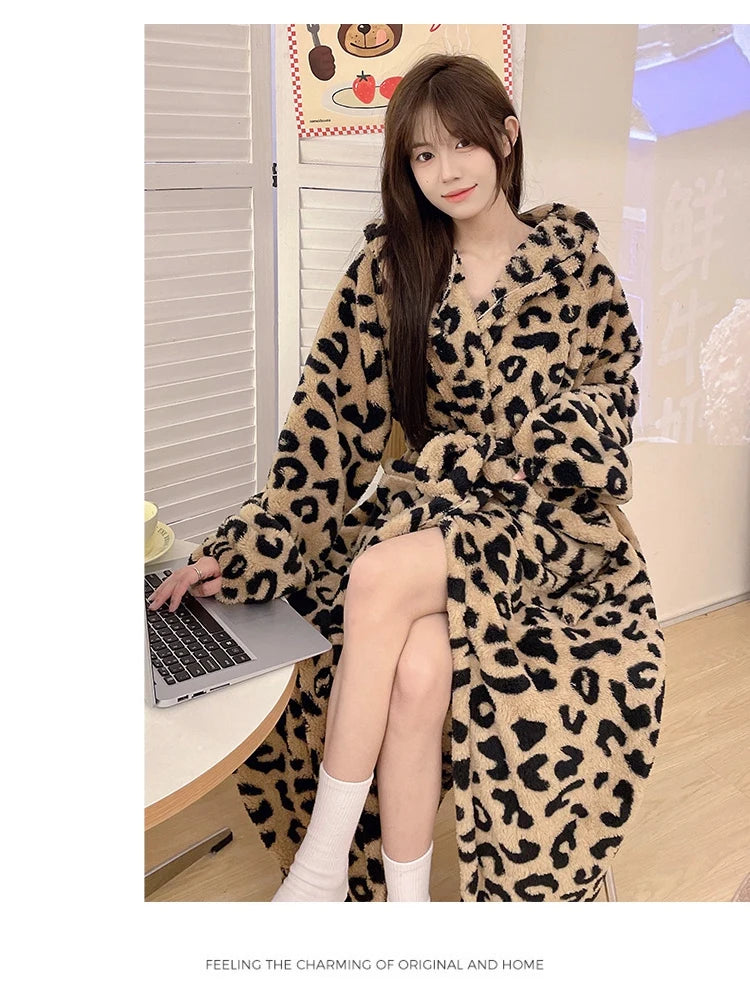 A woman models a leopard print flannel kimono robe indoors.
