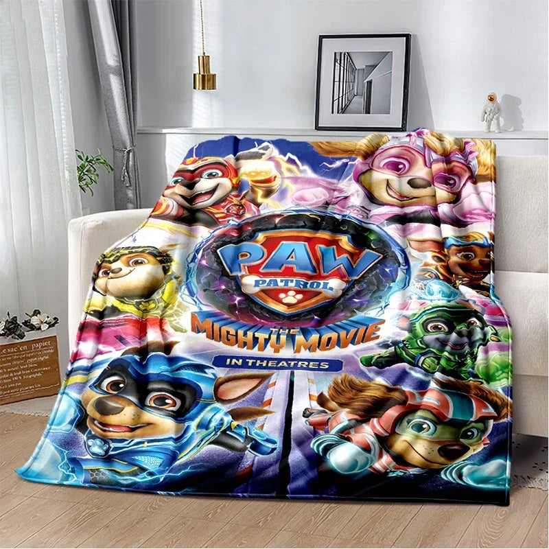 A colorful Paw Patrol themed flannel throw blanket featuring various cartoon dog characters and the Paw Patrol logo.