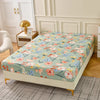 A floral fitted sheet set with pillowcases displayed on a bed in a bright room.