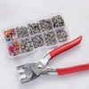 A plastic storage tray filled with a 100-piece metal snap button kit and a press tool.