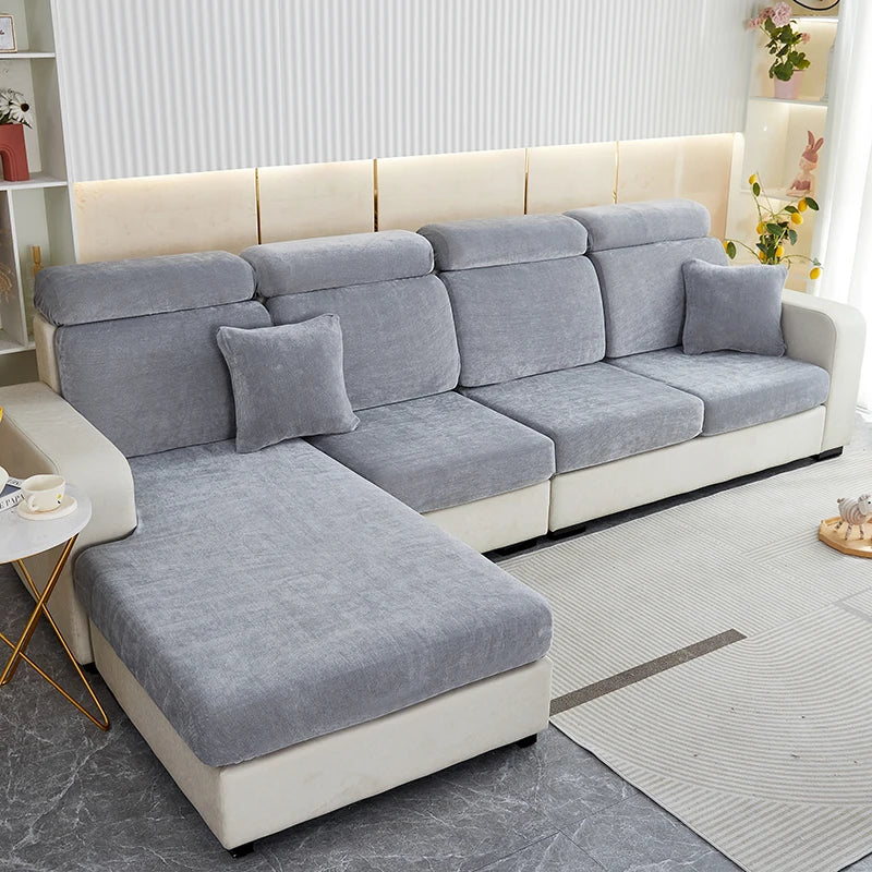 A modern gray stretchable chenille sofa cushion cover on a light wood frame with white upholstery.
