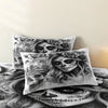 A set of three decorative pillows featuring detailed black and white skulls with floral designs.