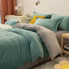 A teal flannel duvet cover set with gray and yellow accents on a bed in a bright room.